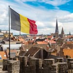 Фото профілю Belgium.ua: прапор Бельгії над міським краєвидом